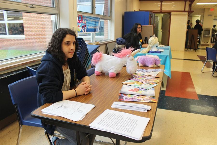 Senior Rivka Buchbinder promotes the 36 Arts poetry slam, taking place April 19, and art share during lunch April 7. The club set out flyers on how to submit art to the magazine. 