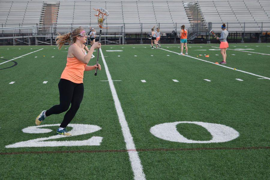 Junior Sofia Roloff cradles the ball during practice April 21. The next girls lacrosse game takes place at 7 p.m. April 28 at Parks stadium.