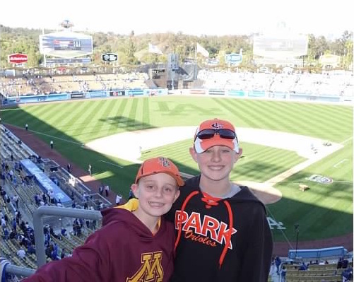 Freshman Cyrus Abrahamson stands with his brother in the Dodgers stadium in Los Angeles. 