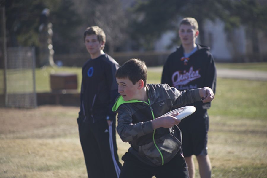 Freshman Mathan Aknin prepares to toss the Frisbee during practice as his teammates, juniors Ronen Pink and Jesse Schwartz, watch from behind.  Ultimate captain junior Jacob Raatz said he loves playing with the team.