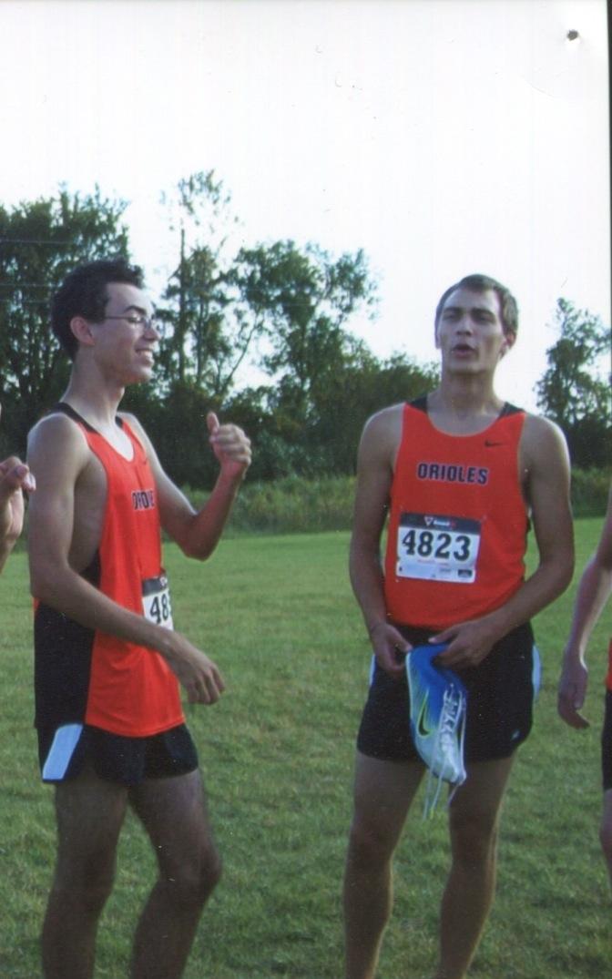 Seniors Raymond Stack and Nick Behnken talk at a cross country meet. Stack joined the  team this past season despite it being his senior year.