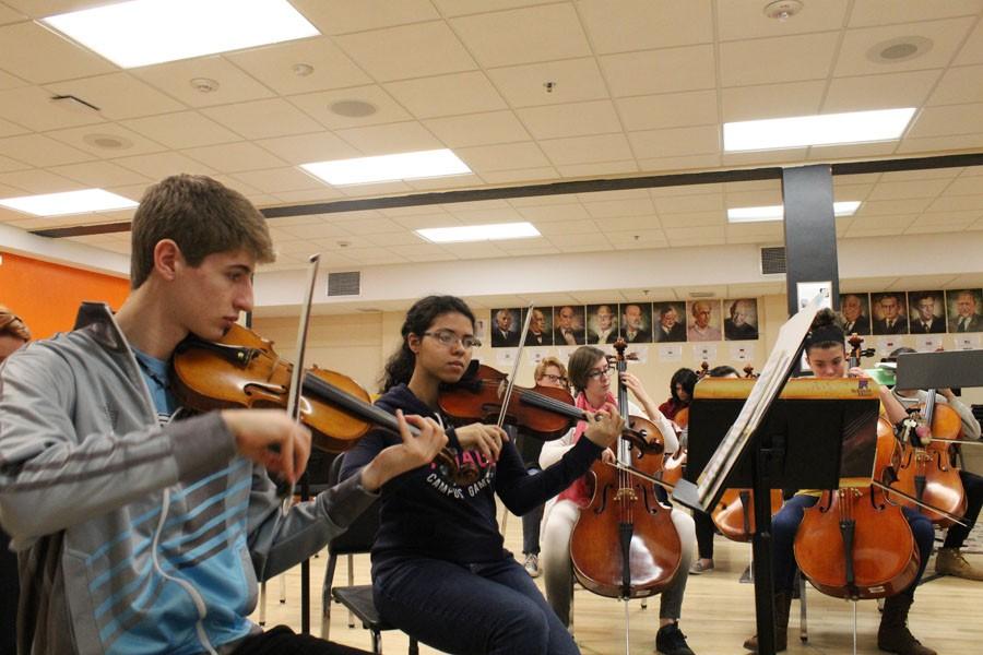 Sophomore Lukas Wrede and senior Claudia Scroggins rehearse the song “Ode to Joy” in preparation for the District Orchestra Festival, which took place at 7 p.m. April 7 in the Fieldhouse. This year, Park is a part of the larger 6AA region.