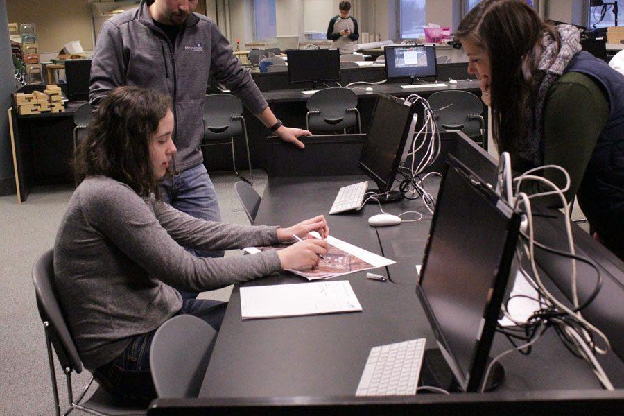 Senior Tess McQuillan and one of her mentors discuss possible ideas for their project Feb. 11. The team scored third place at their final competition. 