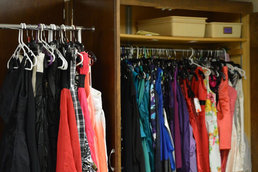 Formal attire hangs on racks at the B226 Dress Closet. Clothes can be donated in room B226.