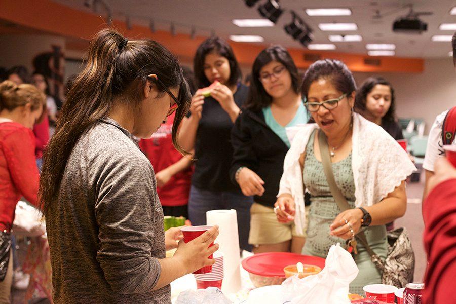 Students eat food during the last Latino Student Association meeting on May 26.