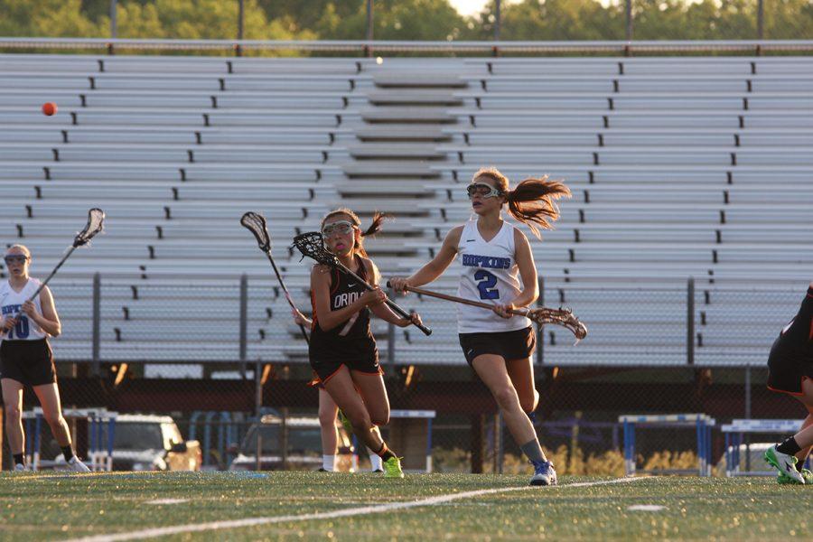 Sophomore+Jade+LaBelle+runs+after+the+lacrosse+ball+during+her+game+against+Hopkins.+The+varsity+girls+sections+game+is+June+2+against+Breck+at+5+p.m.