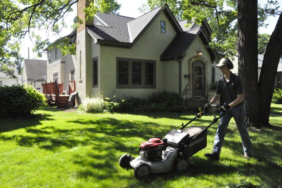 Sophomore Brendan Lindstrom mows a lawn June 2. With a good mix of both sun and rain, Lindstrom said he has a sufficient amount of lawns to mow.