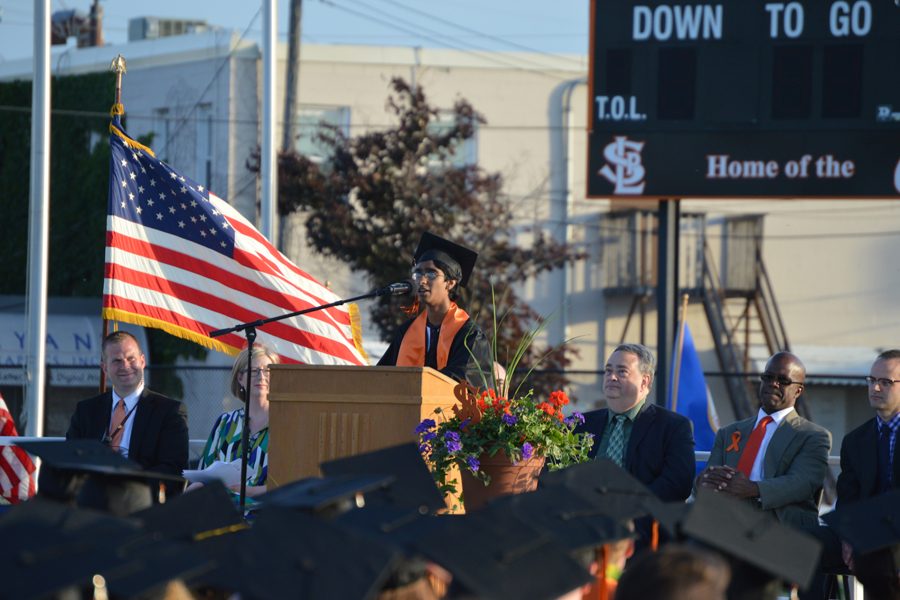 Senior Totaram Brijmohan introduces Elise Hernandez, the recipient for this years Distinguished Alumni award. Hernandez, a Park alumna, is currently the CEO of Ideal System Solutions, Inc. and spoke to the class of 2016 at Graduation. 