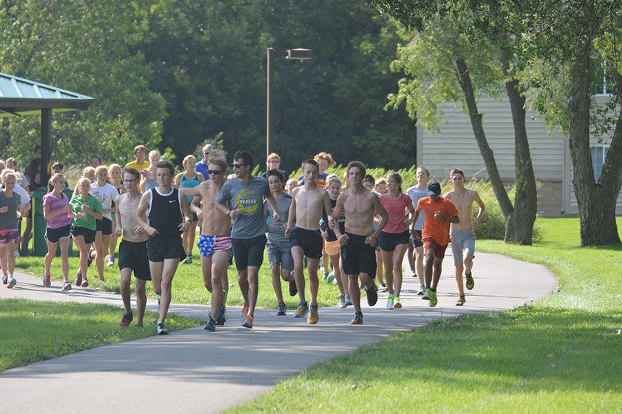 The boys and girls cross country teams start a workout in preparation for their Sept. 15 meet.