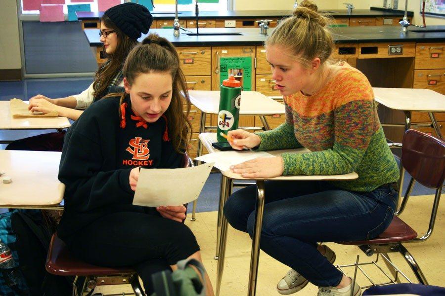 Seniors Anya Lindell Paulson and Alexandra Smith prepare for an upcoming Science Olympiad competition. 