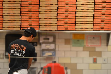 Junior Jackson Lochan cleans up at the end of a day of work at Blaze Pizza. Lochan is one of many students who works during the school year.