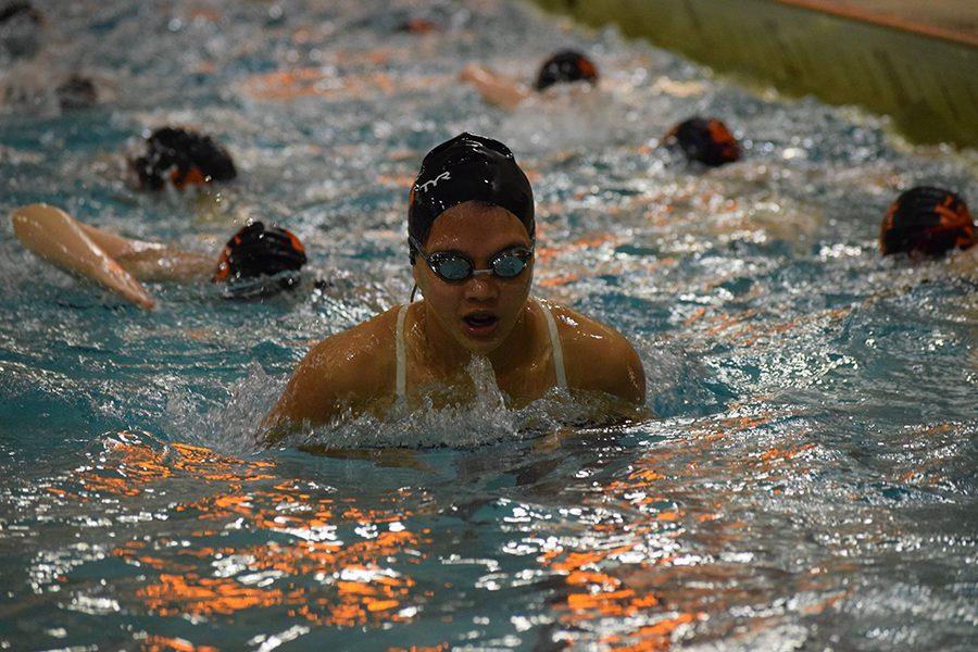 Eighth grader Esther Putzier comes up for a breath while practicing her breaststroke before her meet against Richfield. 