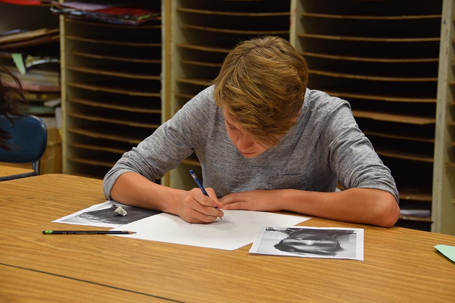 Sophomore Isaak Kimmel works with photo references to create a cubist self-portrait.