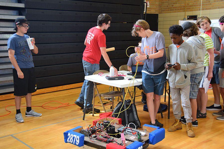 The robotics club present their robots to new students.