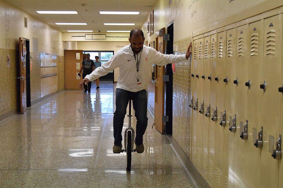 Math teacher Anson Opara practices riding the unicycle before school Sept. 8. Teachers use the time before school or their open hours to improve. 