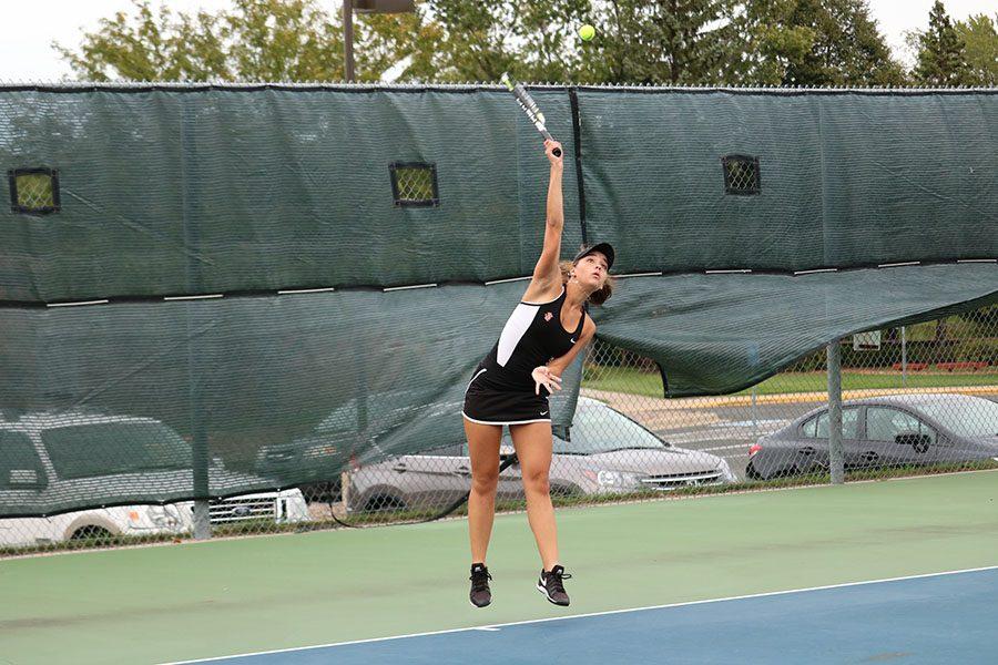 Senior Natalie Lorentz serves in a match against Bloomington Kennedy High School. Lorentz helped propel the girls tennis team to a 7-0 win Tuesday.