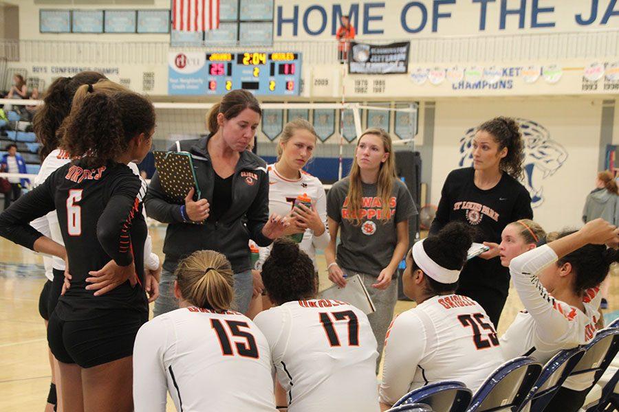 Assistant varsity coach Megan Hansen gives the girls encouragement after the second set during their game against Bloomington Jefferson on Sept. 27.