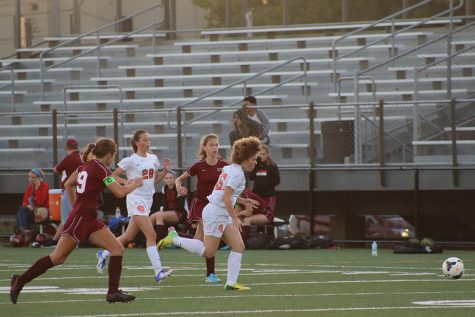 Senior Sofia strides for the ball as she is pressured by 2 Richfield opponents. The team won 8-0 and included seniors from JV and varsity in the senior night game.
