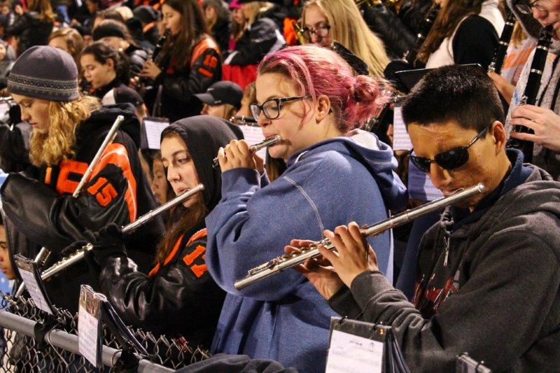 Junior flutist Jamison Christopher and senior flutists Maddie Cook and Sammie Ebbing play at halftime during the Homecoming football game Oct. 7.