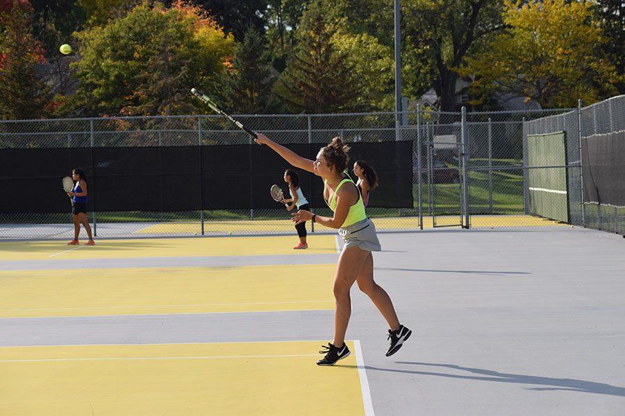 Senior Natalie Lorentz serves the ball while playing doubles. Individual matches for sections will be held on Monday Oct. 17.