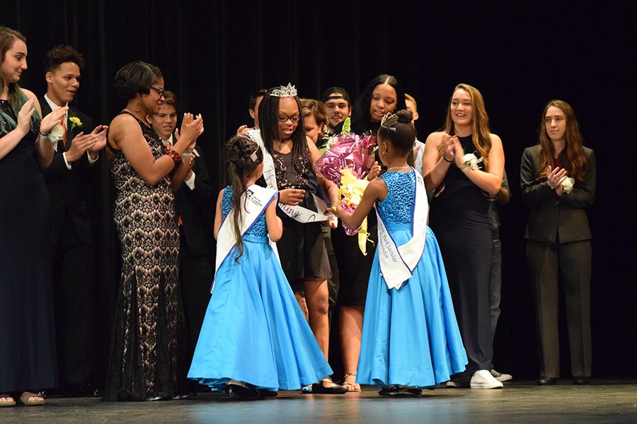 St. Louis Park Jr. Ambassadors give queen Bre Dickens her flowers and sash.
