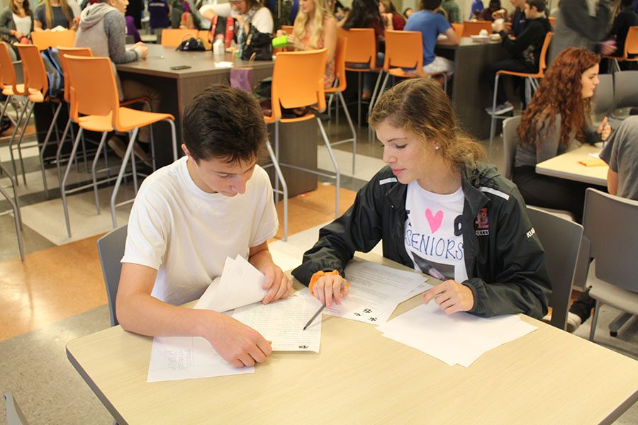 Juniors Rafferty Kugler and Jacob Stillman meet to work on the club application forms during their lunch.