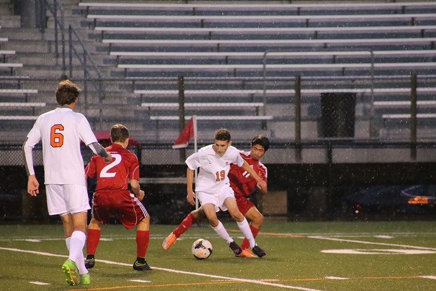 Junior Charles Schuebel plays on despite the rain at the boys game Oct. 6 against Benilde-St. Margarets. The boys next game is Oct. 13 at 5pm at Hopkins High School.