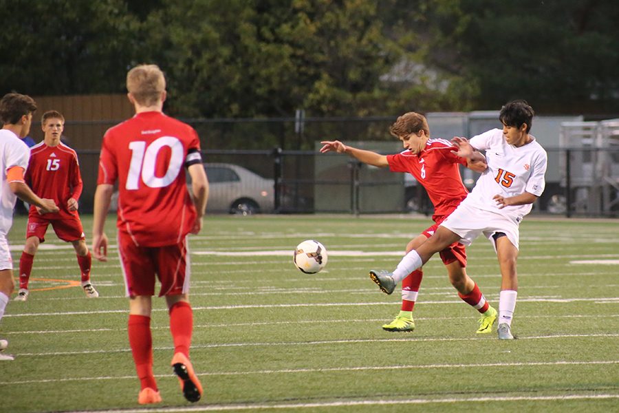 Sophomore Fabio Leyva prevents an opponent from obtaining the ball in the boys game against Benilde-St. Margarets Oct. 6. The boys next game is Oct. 13 at 5pm at Hopkins High School.