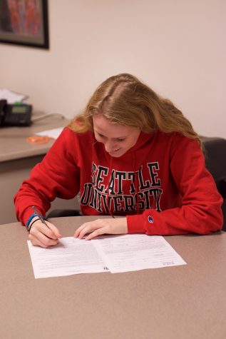 Senior Kailey DeLozier signs her commitment to Seattle University for Division 1 swimming. She signed the contract Nov. 9.