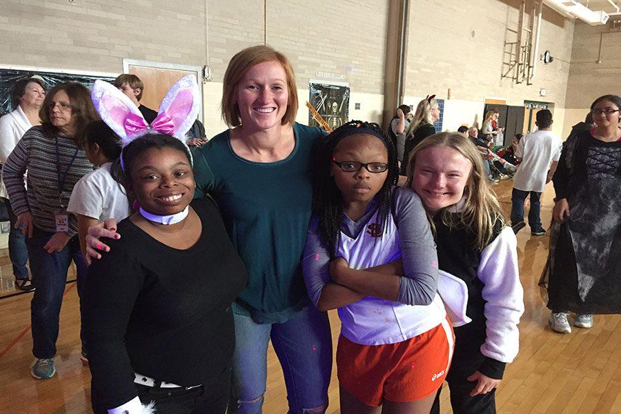 Special Education staff member Christine Tvrdik poses with students at the Halloween party hosted by Transition Plus on Oct. 28th.