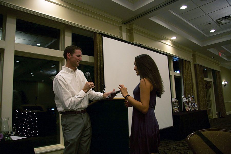 Varsity coach Dave Britenbucher congrats Racquel Fhima as he hands her, her letter.