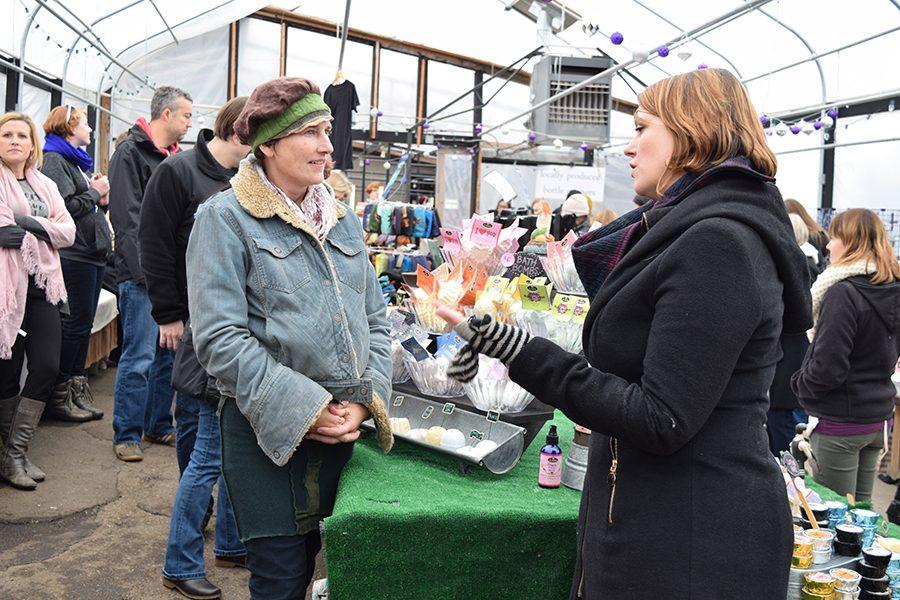Vendor and customer discuss products at the Linden Hills Holiday Market Nov. 27.
