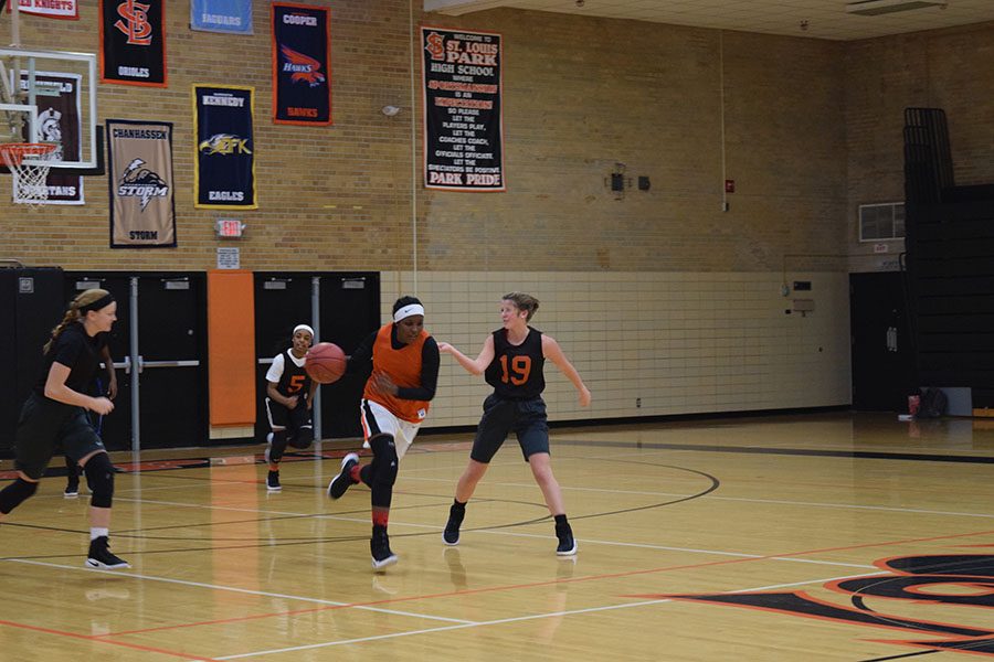 Senior Yusra Jara dribbles the ball while senior Stephanie Reuter plays defense on her at practice.