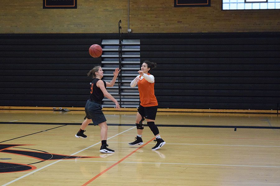 Senior Stephanie Reuter blocks junior Olivia Massies pass at their practice Nov. 30. Practices take place after school in the old gym.