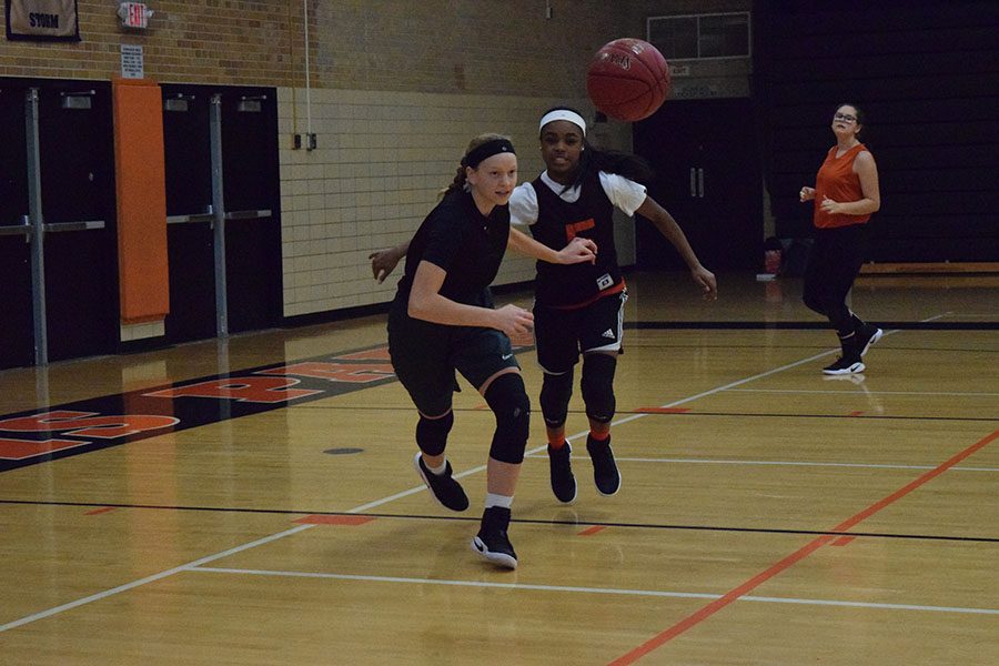 Junior Lindsey Olsen goes in to steal the ball from junior Kamil Mayfield during practice Nov 30.