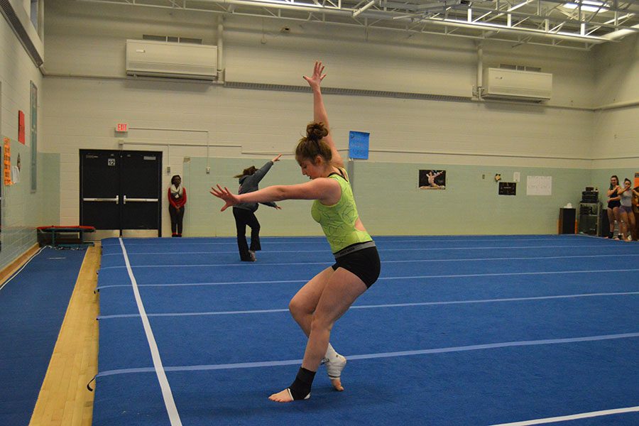 Sophomore Savannah Romero practices her floor routine on the new floor at the Central gymnasium. The old floor was replaced due to a tear.