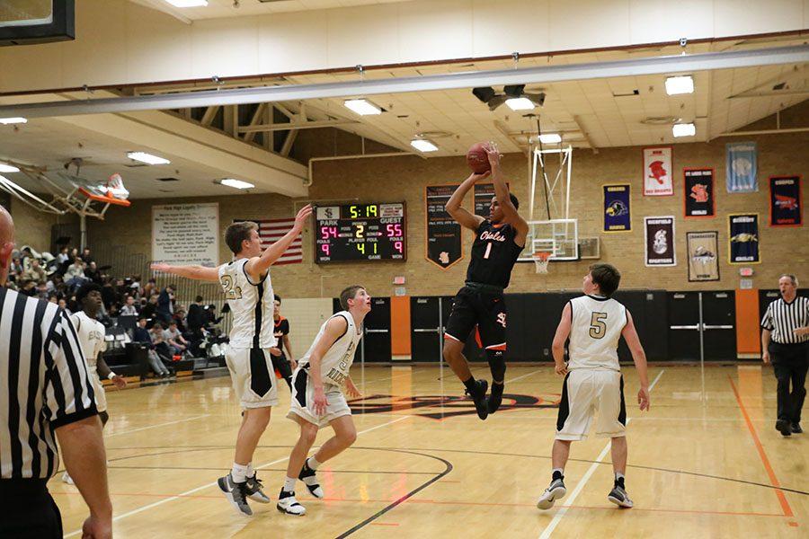 Senior Mikel Howard shoots the ball over an East Ridge player Dec. 13. Park lost the game 65-69.