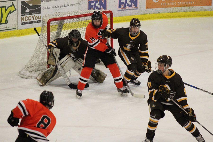 Senior captain Bauer Neudecker takes a shot on goal as senior Grant Plender screens the goaltender. The Orioles went on to beat Apple Valley by a score of 6-3.  Used with written permission from Mikel Kieselbach.