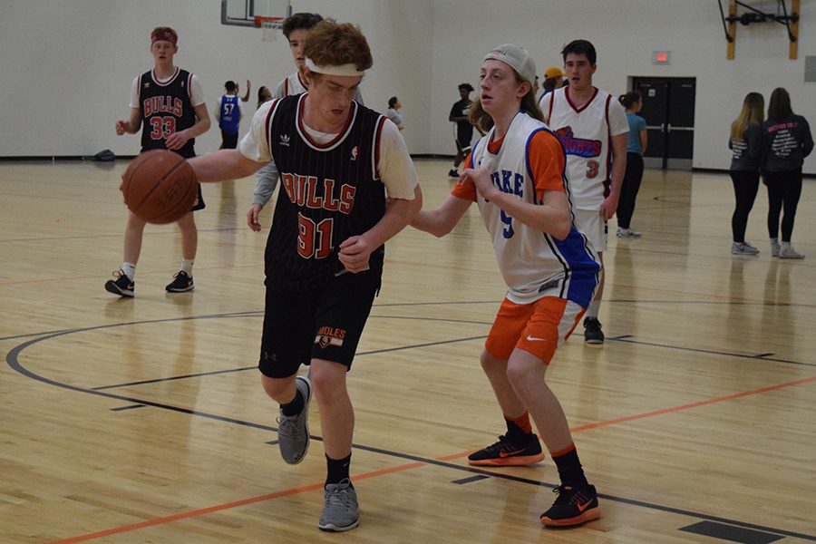 Sophomore ____ guards junior Shea Pekarek as he dribbles the ball during their game Feb. 21 in the field house. 