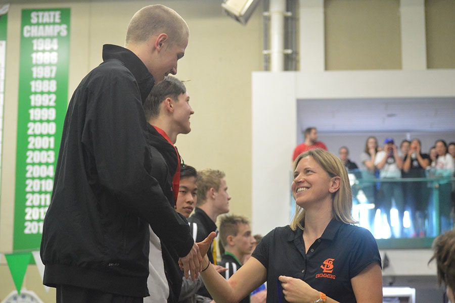 Head coach Amanda Forsberg congratulates senior captain Nils Rykken after his first place finish in the 50-yard freestyle. Park finished third overall. 