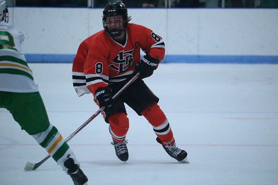 Senior Captain Bauer Neudecker skates down the ice on a fast break. Neudecker recently committed to play hockey at the University of Alabama-Huntsville in 2019.