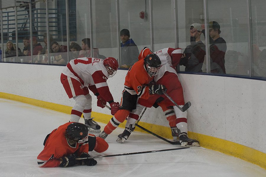 Juniors Brent Ryan and Jonny Sorensen battle behind the net to get possession of the puck in the third period. Sorensen scored near the end of the period to give the Orioles a 5-3 lead Feb. 23.