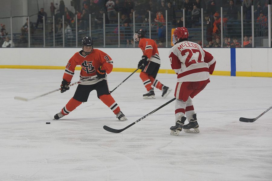Junior Sam Baker takes a shot from the blue line. Baker had an assist in the win. 