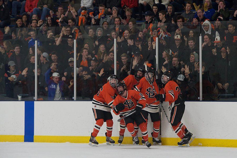 The Orioles celebrate after senior Bauer Neudecker scores to tie the game 3-3 in the third period. 