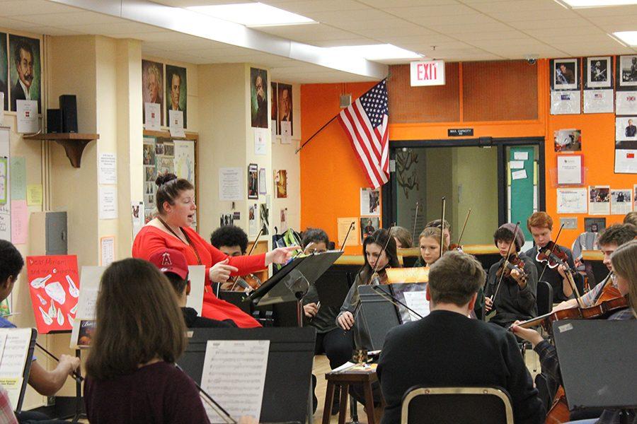 Orchestra director Miriam Edgar conducts the orchestra in their preparation for their upcoming conference performance, which will be held at Benilde-St.Margarets Feb. 8.