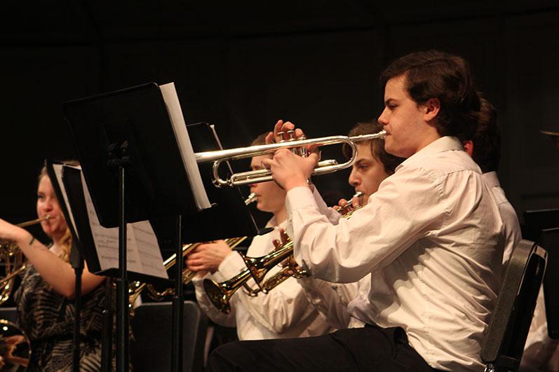 Junior Owen Erickson plays the trumpet during the POPS band concert March 6. Erickson is part of the Symphonic Band.