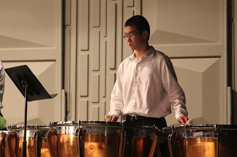Junior Kurt Nystuen plays the drums at the POPS concert on March 6. Nystuen is part of the percussion ensemble. 