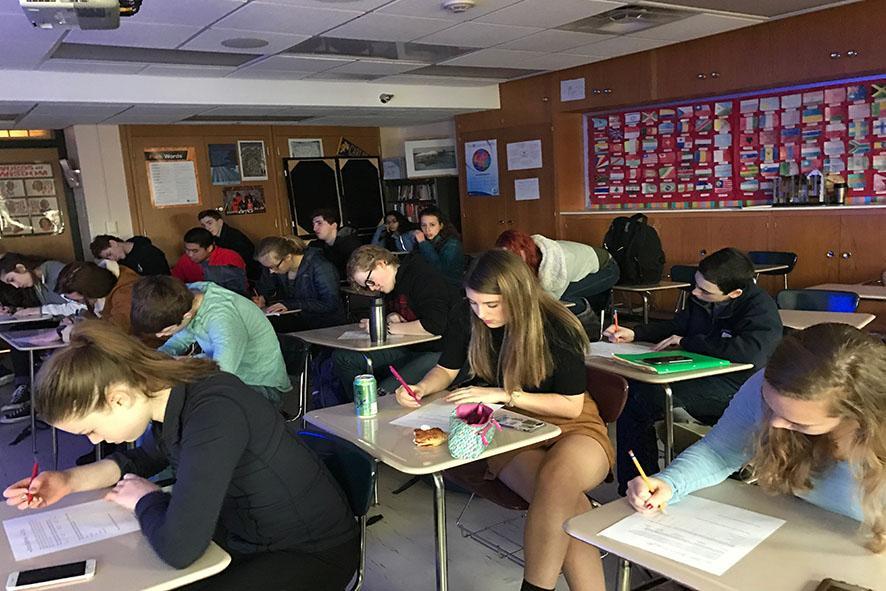Feminism Club members fill out evaluation sheets for Krebs project. Krebs said she received positive feedback, as well as constructive criticism to help her improve her presentation for the future.