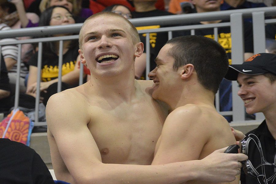 Senior captain Nils Rykken and junior David Salamzadeh celebrate after the 200-yard medley relays eighth place finish in prelims. The relay swam in finals in a 1:38.04. 