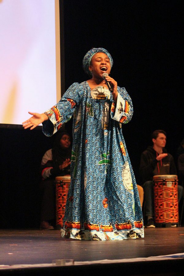 Senior Eben Managbe sings Waving Flag during the Cultural Day show March 7. She wore traditional Cameroon clothing.